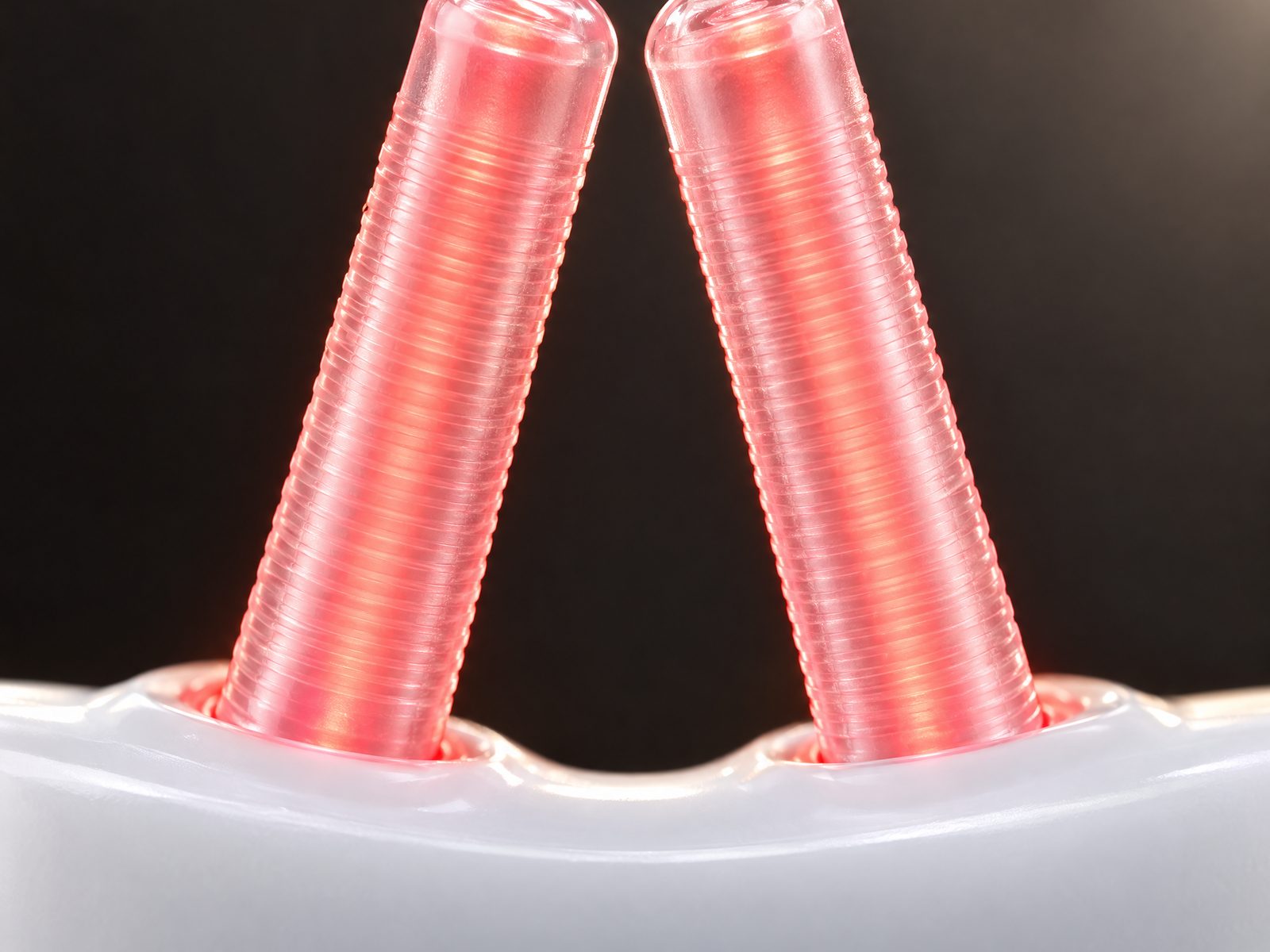 Close-up of the two slim sleeves of Vantrel Lumen, lit red
